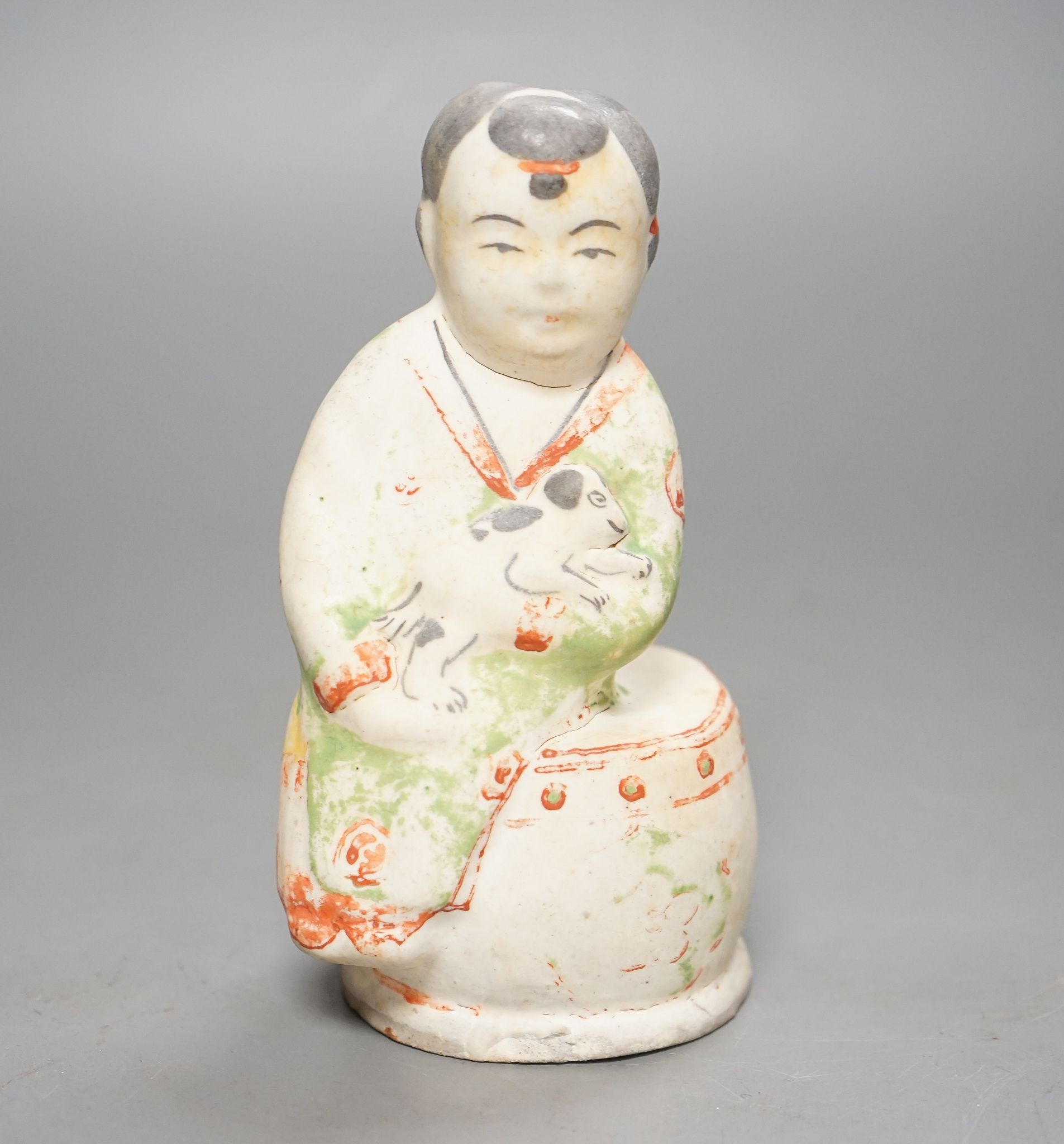 A Chinese Ming cizhou enamelled pottery group of a boy and dog, with case, 14cm